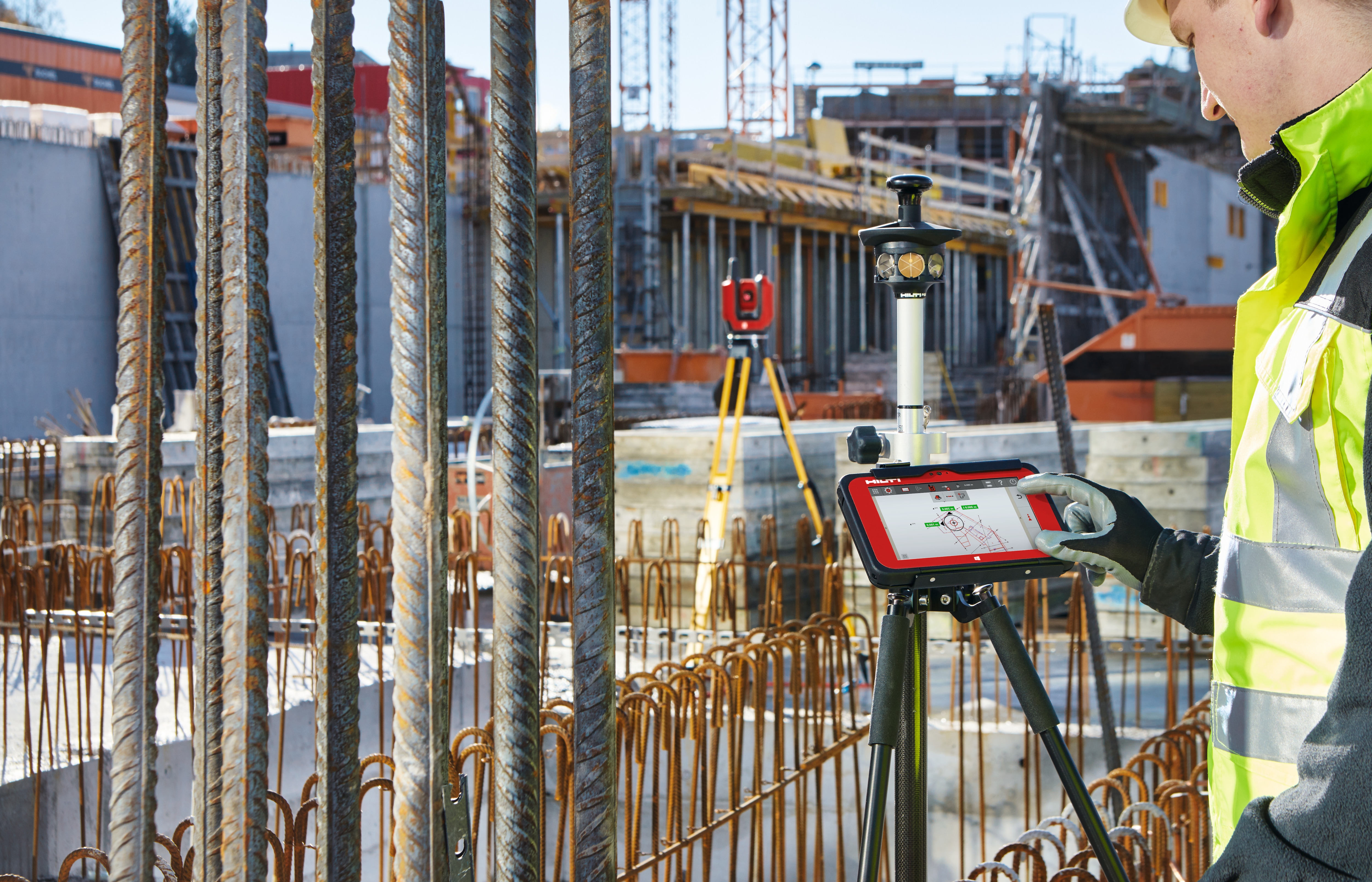 A man on a construction site using Hilti onsite software