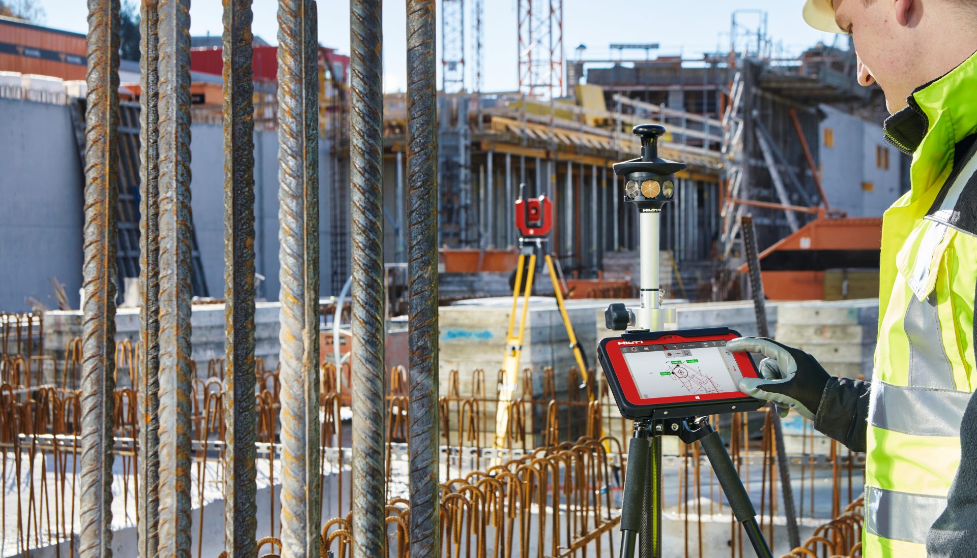 A man on a construction site using Hilti onsite software