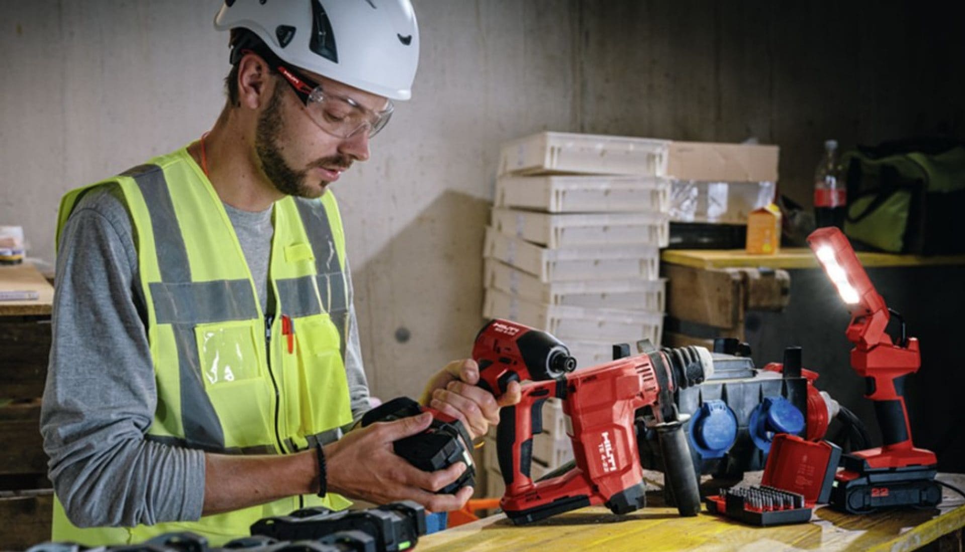 a worker changing the battery of a drill