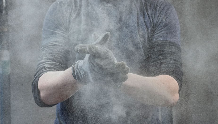 person expelling dust from gloves