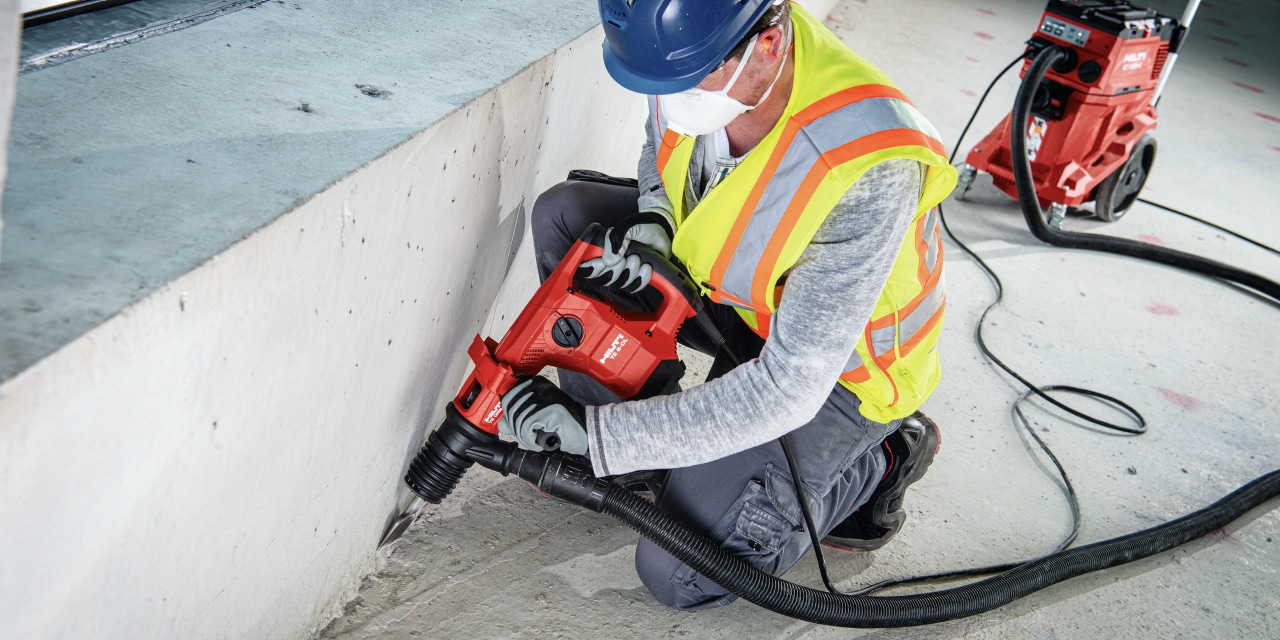 hilti drill being used with a dust removal system and vacuum cleaner for virtually dust-free chiseling / breaking