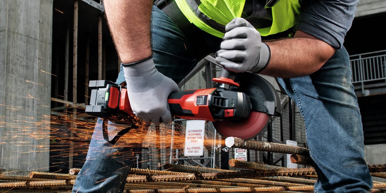 person using an angle grinder to cut metal rod
