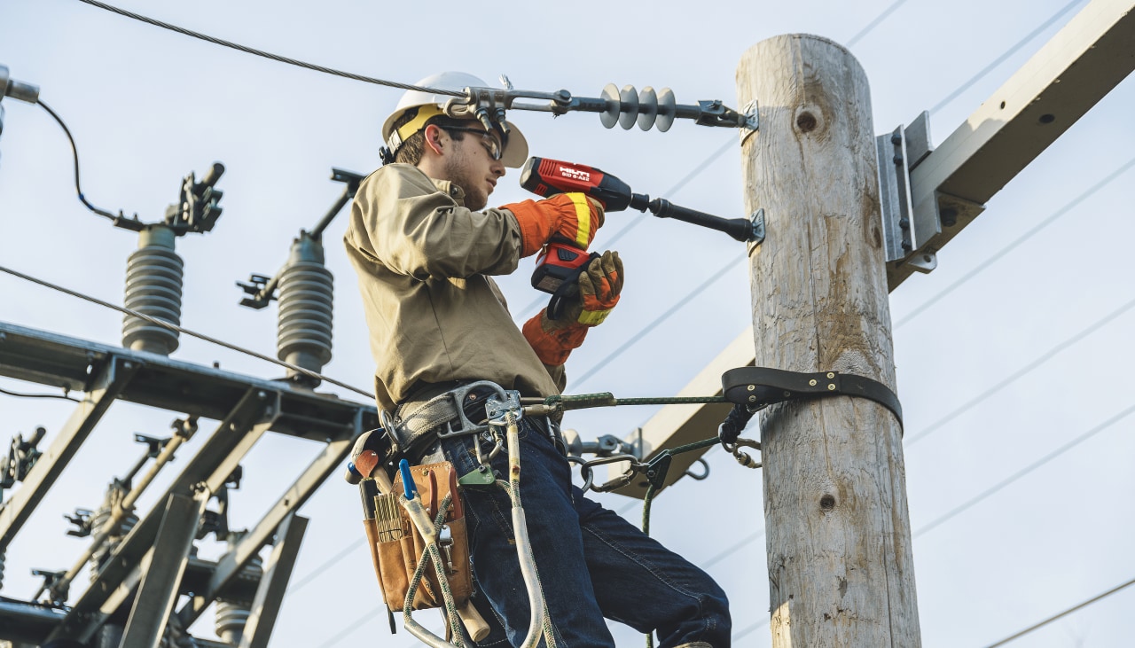 man fixing an electric pole