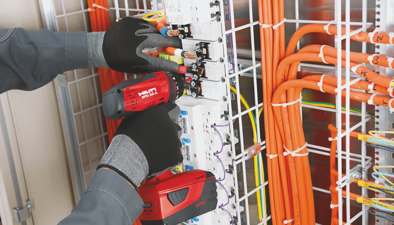 man fixing electrical connections on a board