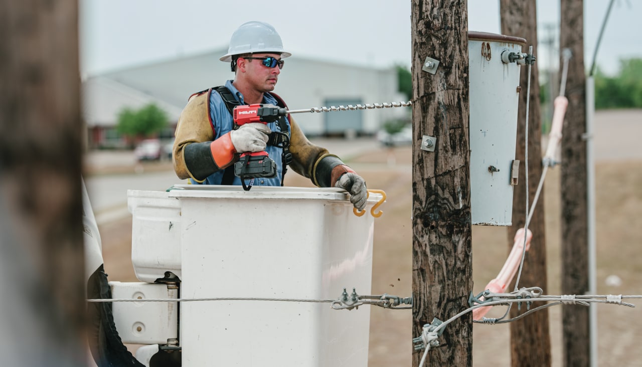 man fixing an electric pole