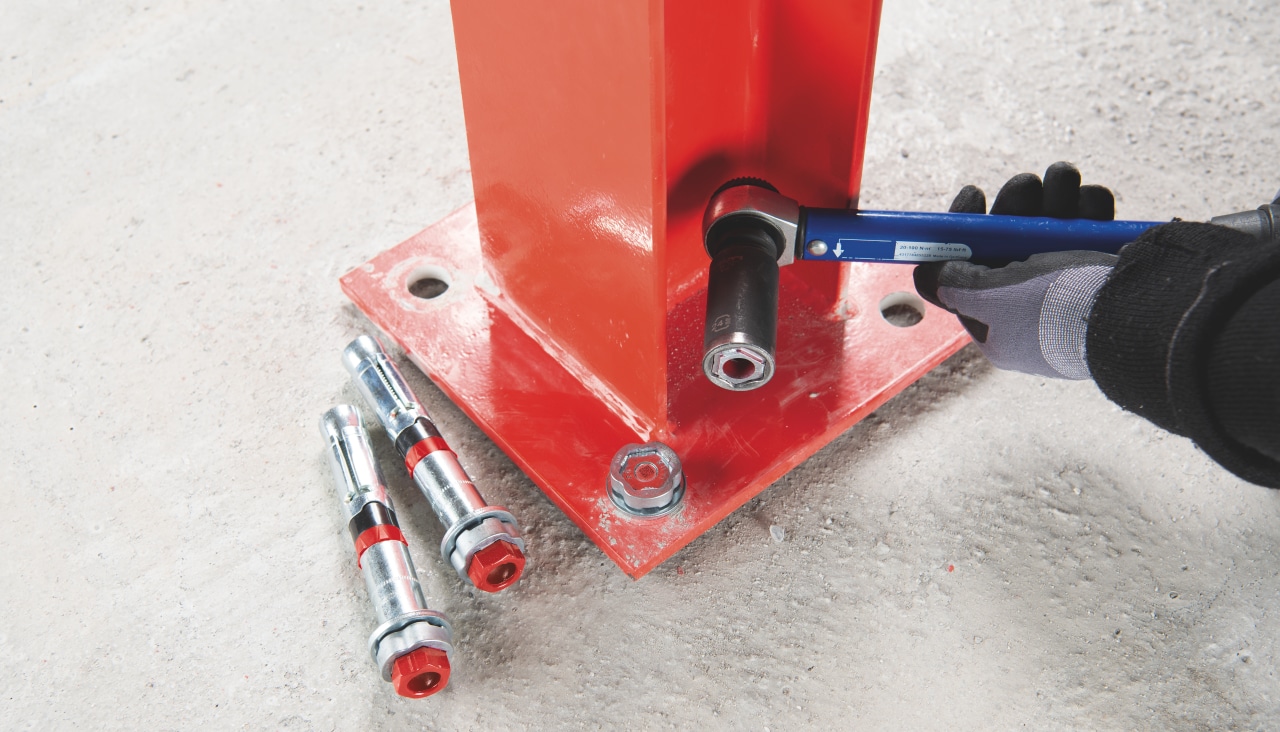 man fastening metal to concrete