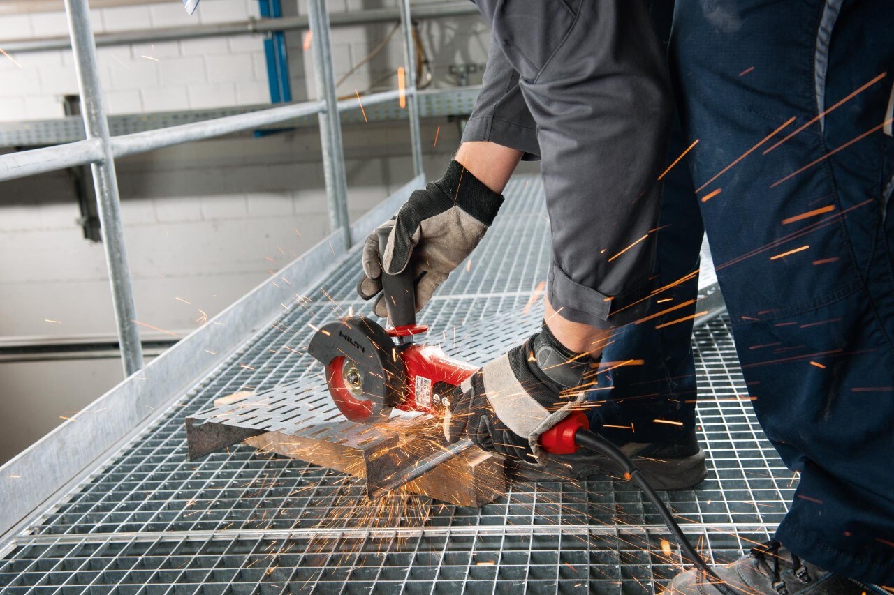 Construction worker using an angle grinder
