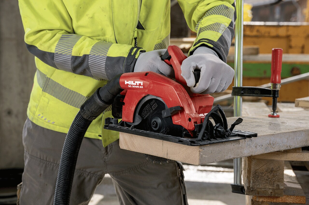 Construction worker using a circular saw to cut wood
