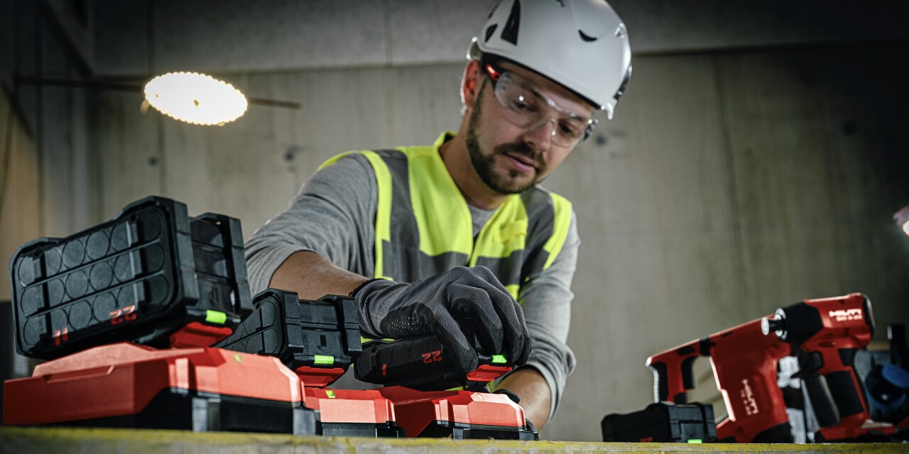man charging batteries on the jobsite