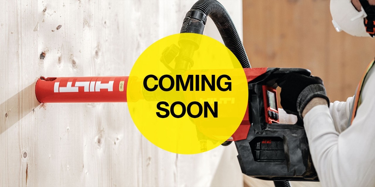 person using a red hilti diamond core drill in concrete wall
