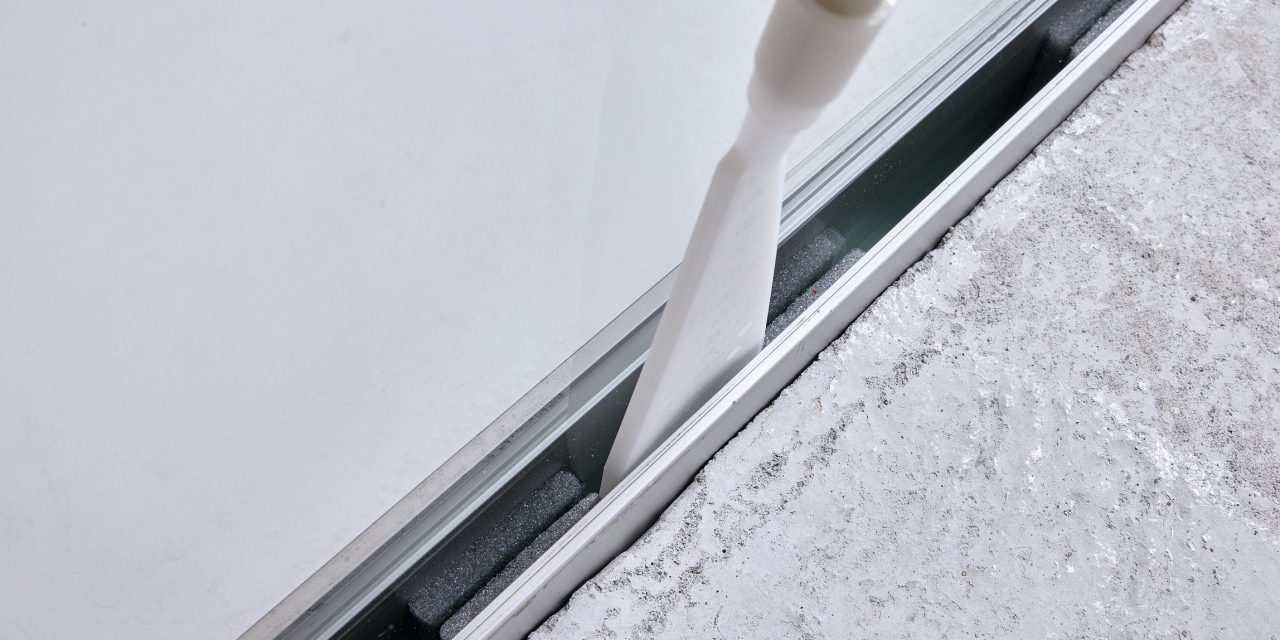 man injecting the foam into glass with Hilti's glass attachment