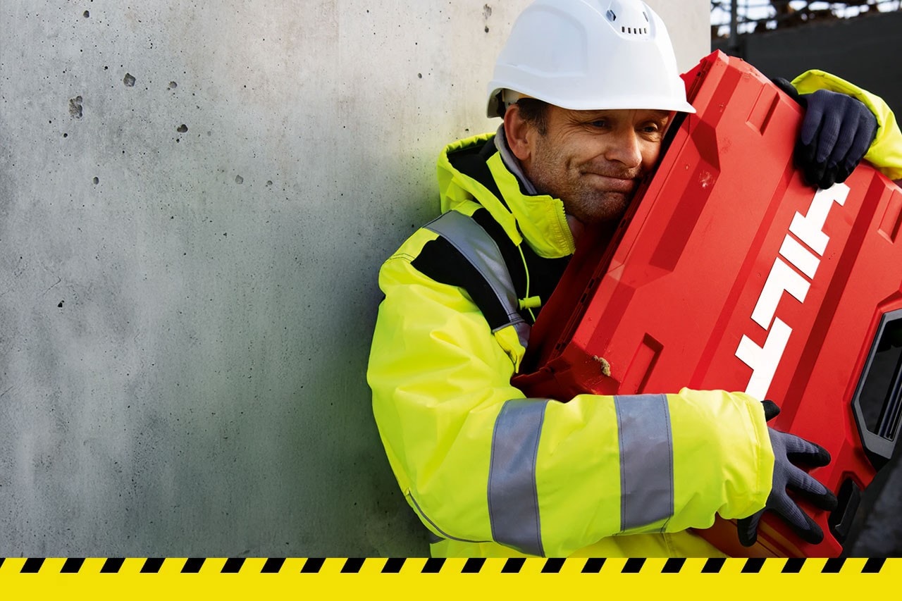Man hugging a Hilti tool box