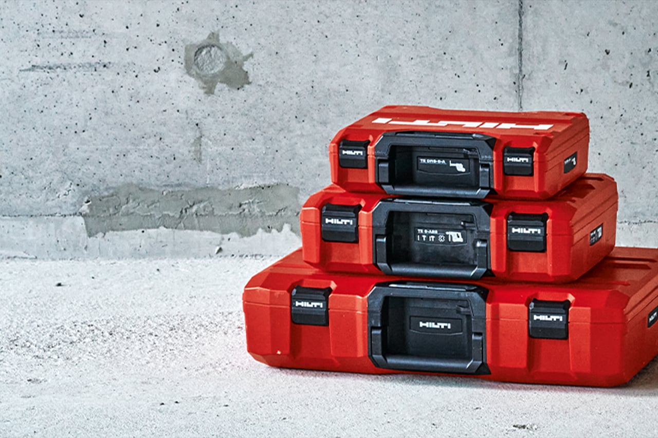 stack of three red Hilti tool cases