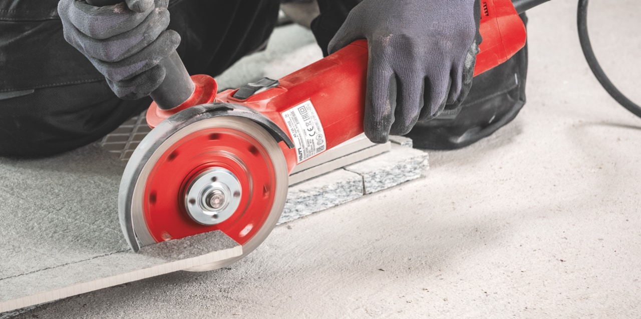 construction worker using Hilti angle grinder