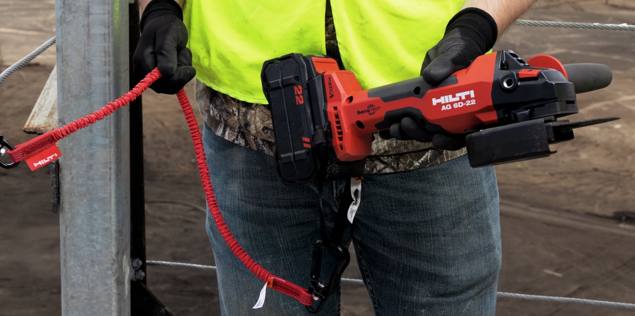 construction worker using Hilti angle grinder