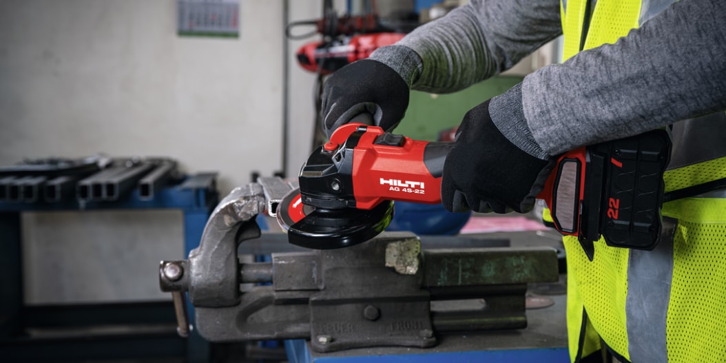 construction worker using Hilti angle grinder