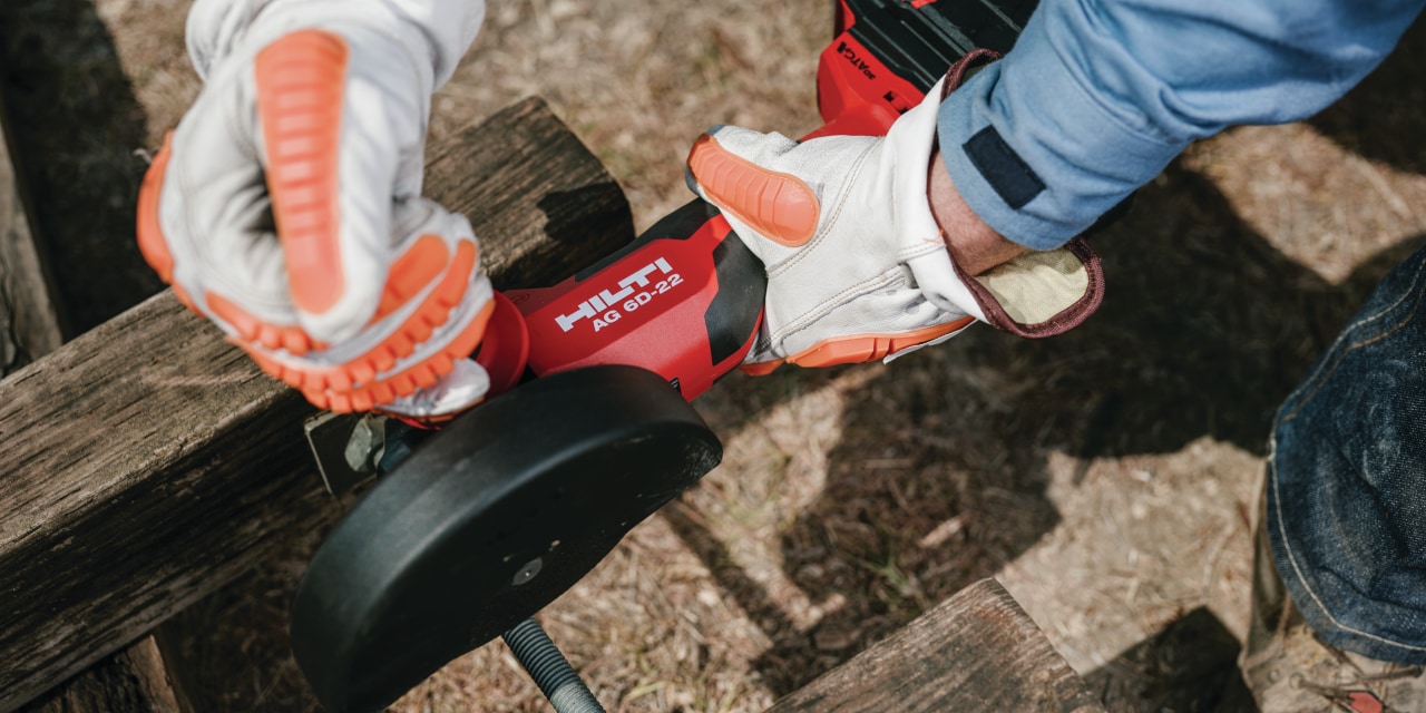 construction worker using Hilti angle grinder