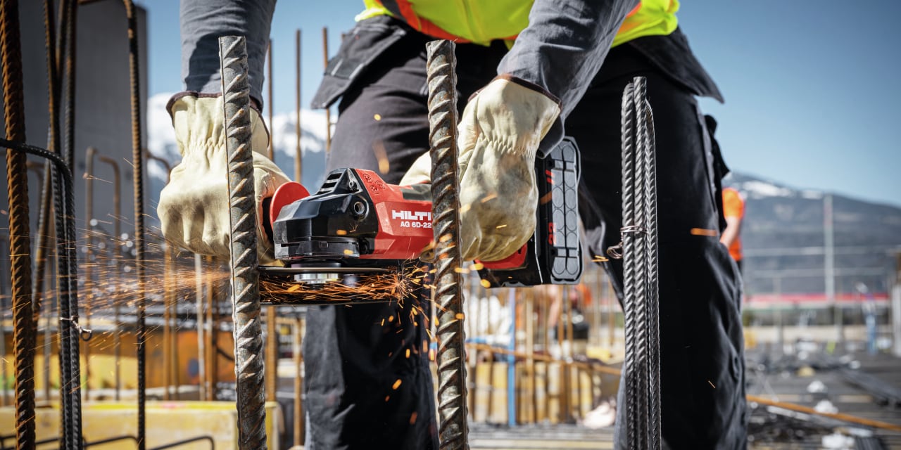 construction worker using Hilti angle grinder