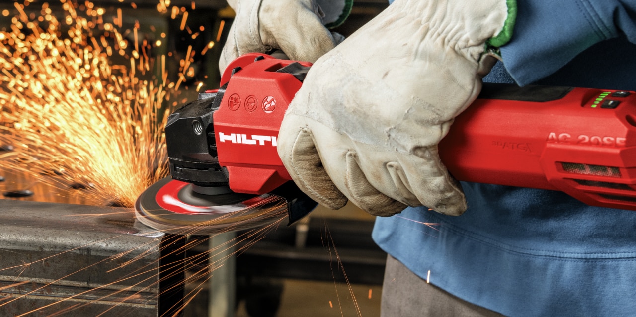 construction worker using Hilti angle grinder