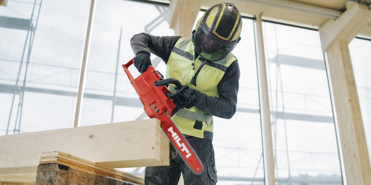man using cordless chainsaw