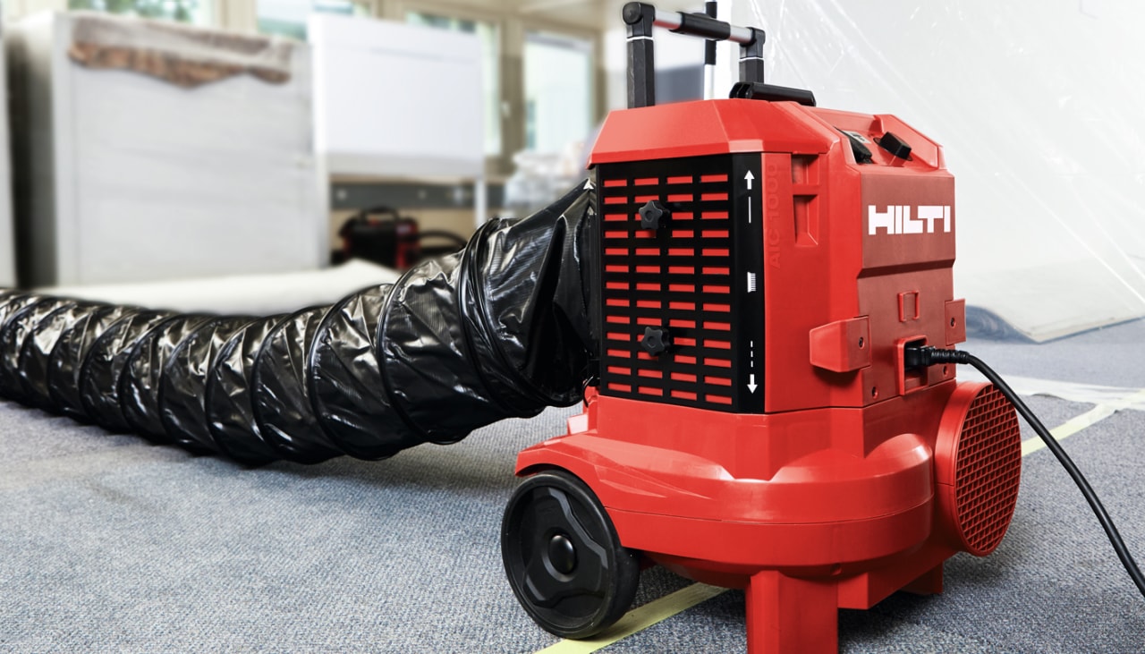 a red hilti air cleaner with black ducting